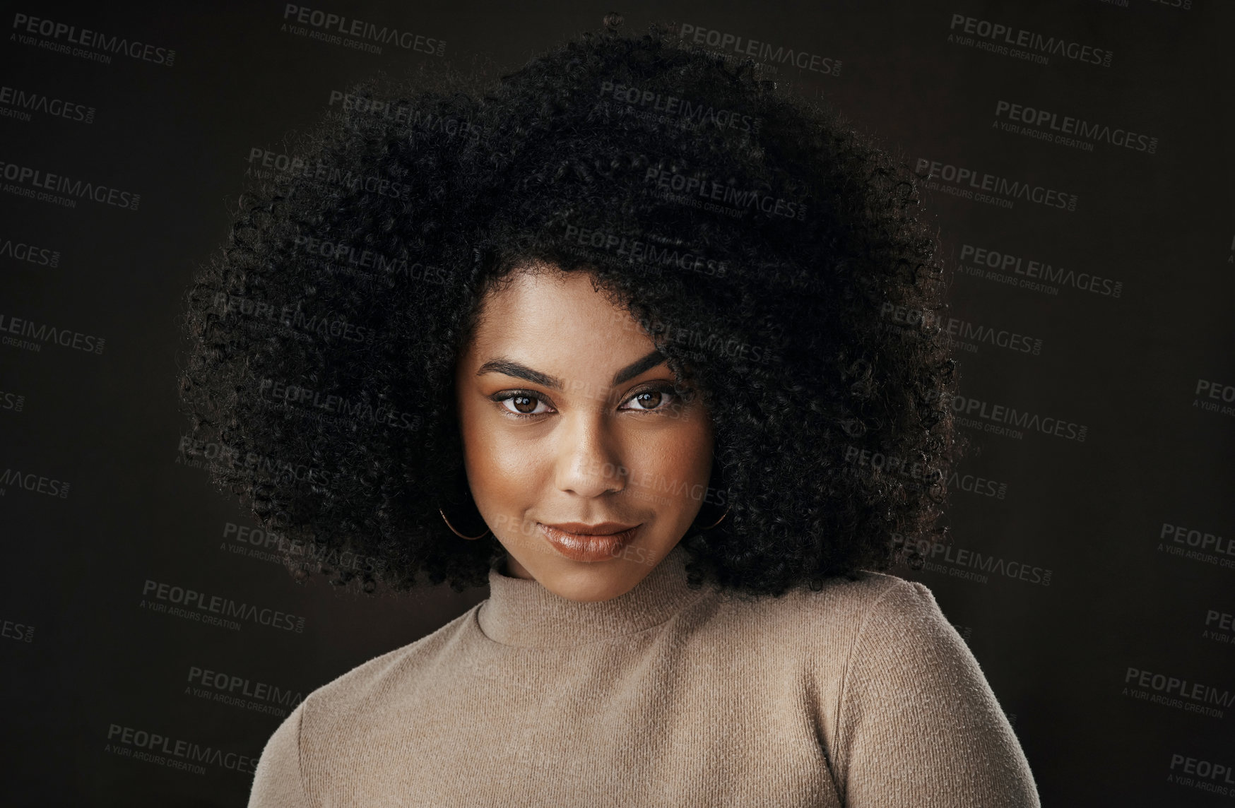 Buy stock photo Cropped portrait of an attractive young woman posing in studio against a dark background