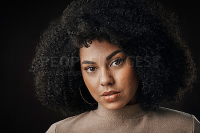 Buy stock photo Cropped portrait of an attractive young woman posing in studio against a dark background
