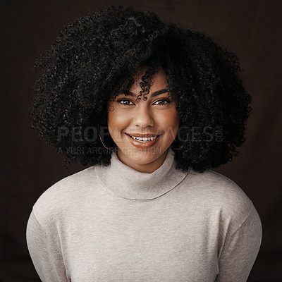 Buy stock photo Cropped portrait of an attractive young woman posing in studio against a dark background