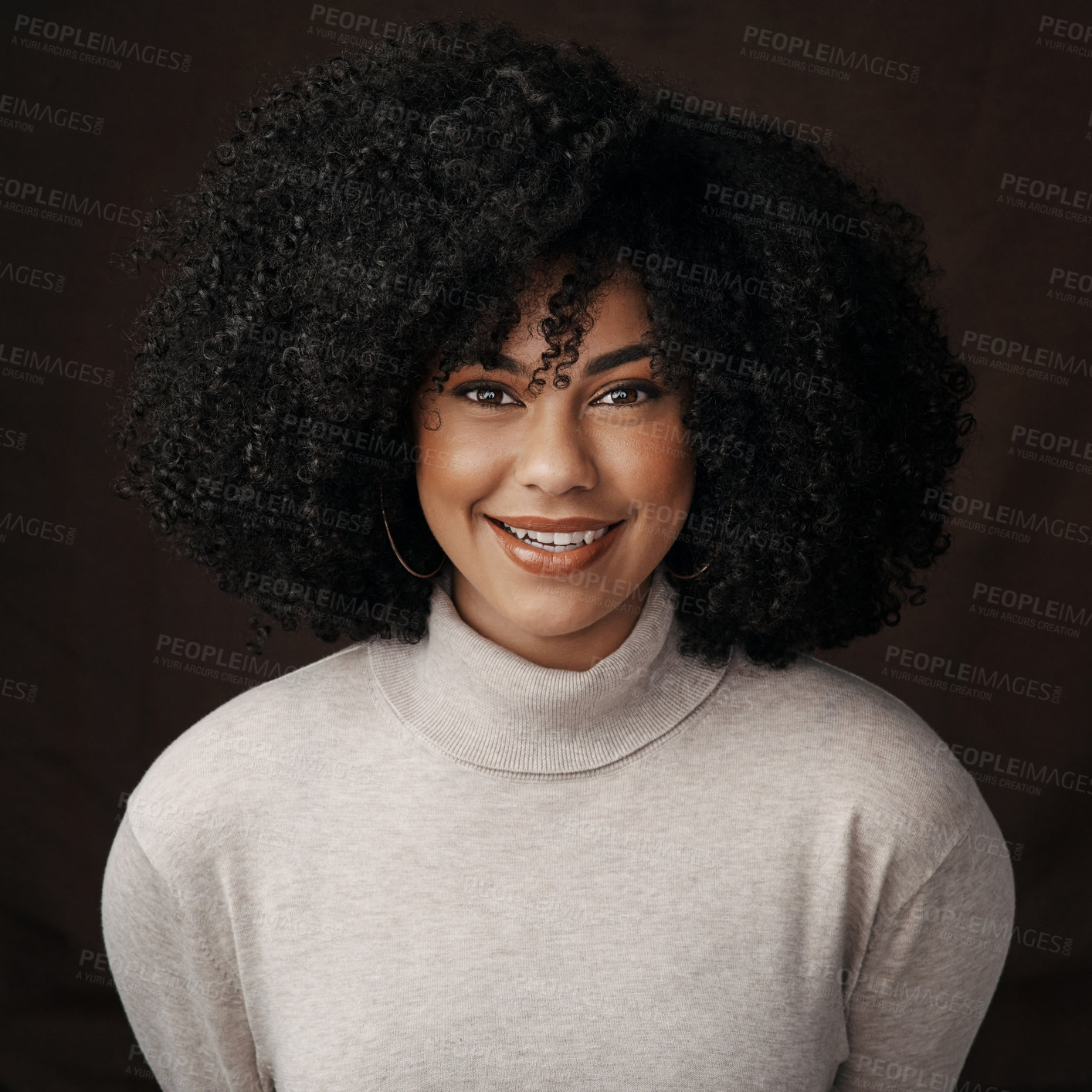 Buy stock photo Cropped portrait of an attractive young woman posing in studio against a dark background