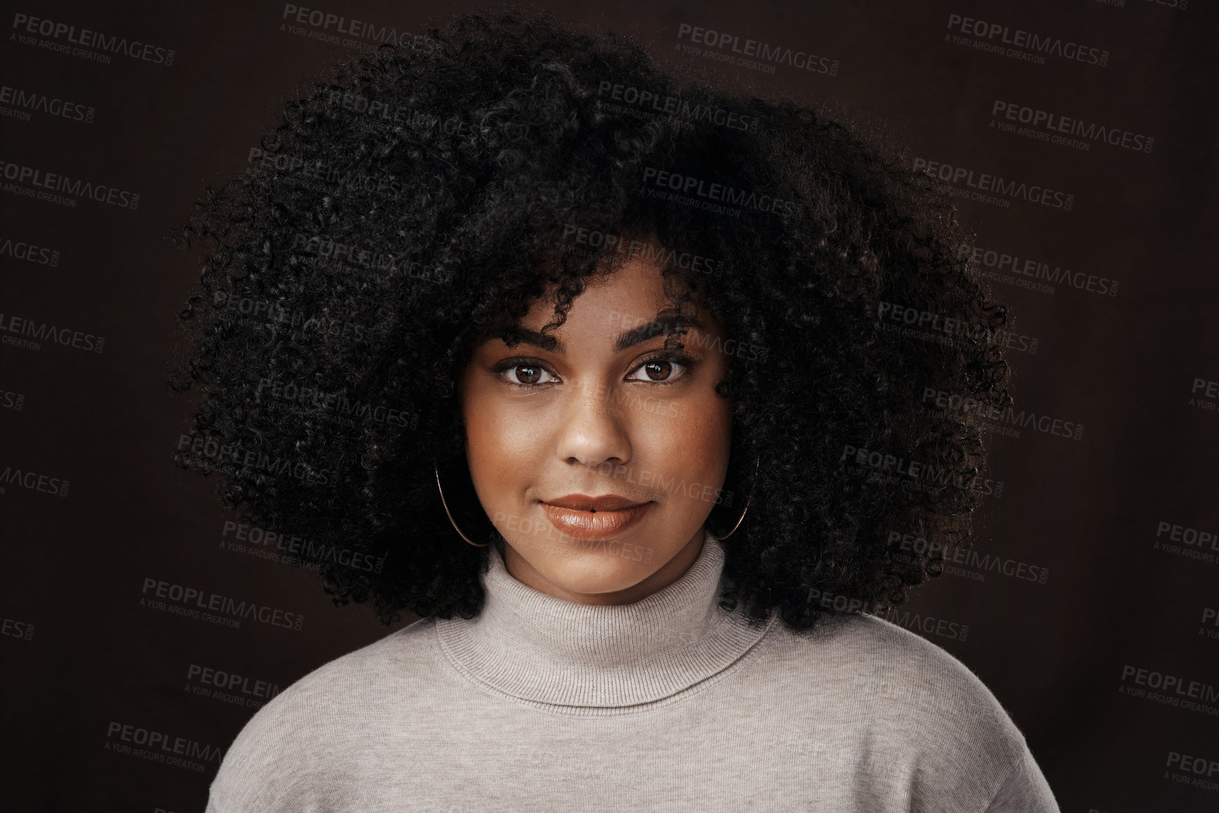 Buy stock photo Cropped portrait of an attractive young woman posing in studio against a dark background