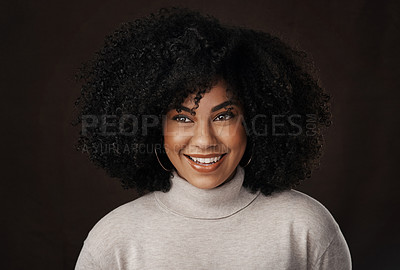 Buy stock photo Cropped shot of an attractive young woman looking thoughtful while posing in studio against a dark background