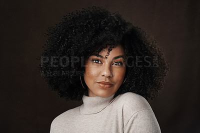 Buy stock photo Cropped portrait of an attractive young woman posing in studio against a dark background