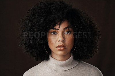 Buy stock photo Cropped portrait of an attractive young woman posing in studio against a dark background