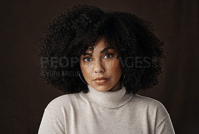 Buy stock photo Cropped portrait of an attractive young woman posing in studio against a dark background