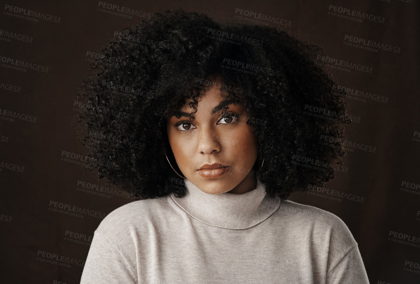 Buy stock photo Cropped portrait of an attractive young woman posing in studio against a dark background