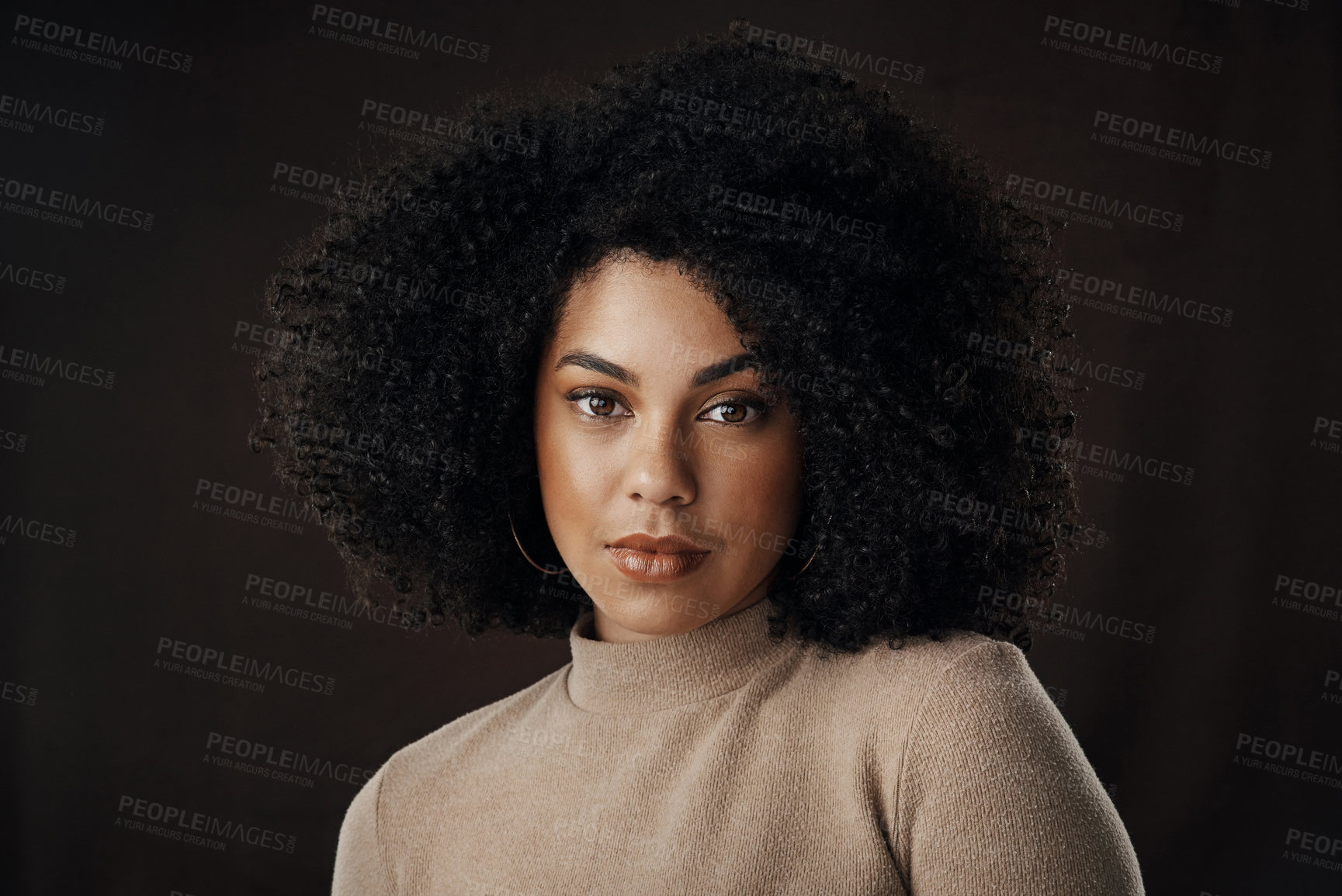 Buy stock photo Cropped portrait of an attractive young woman posing in studio against a dark background