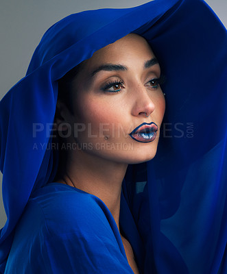 Buy stock photo Studio shot of a beautiful young woman looking thoughtful while posing against a grey background