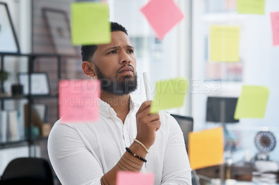 Buy stock photo Serious man, thinking and brainstorming notes of business, solution, strategy and mindmap at glass window. Focused face of male worker planning schedule, problem solving and ideas for project goals