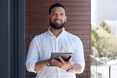 Buy stock photo Portrait of a young businessman using a digital tablet outside an office