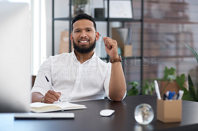 Buy stock photo Portrait of a young businessman writing notes in an office