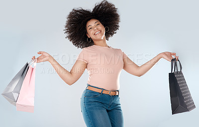 Buy stock photo Woman, jump and excited with shopping bag and smile in portrait, retail and happy customer on studio background. Happiness over sale, discount or promotion, female person in air and luxury fashion 