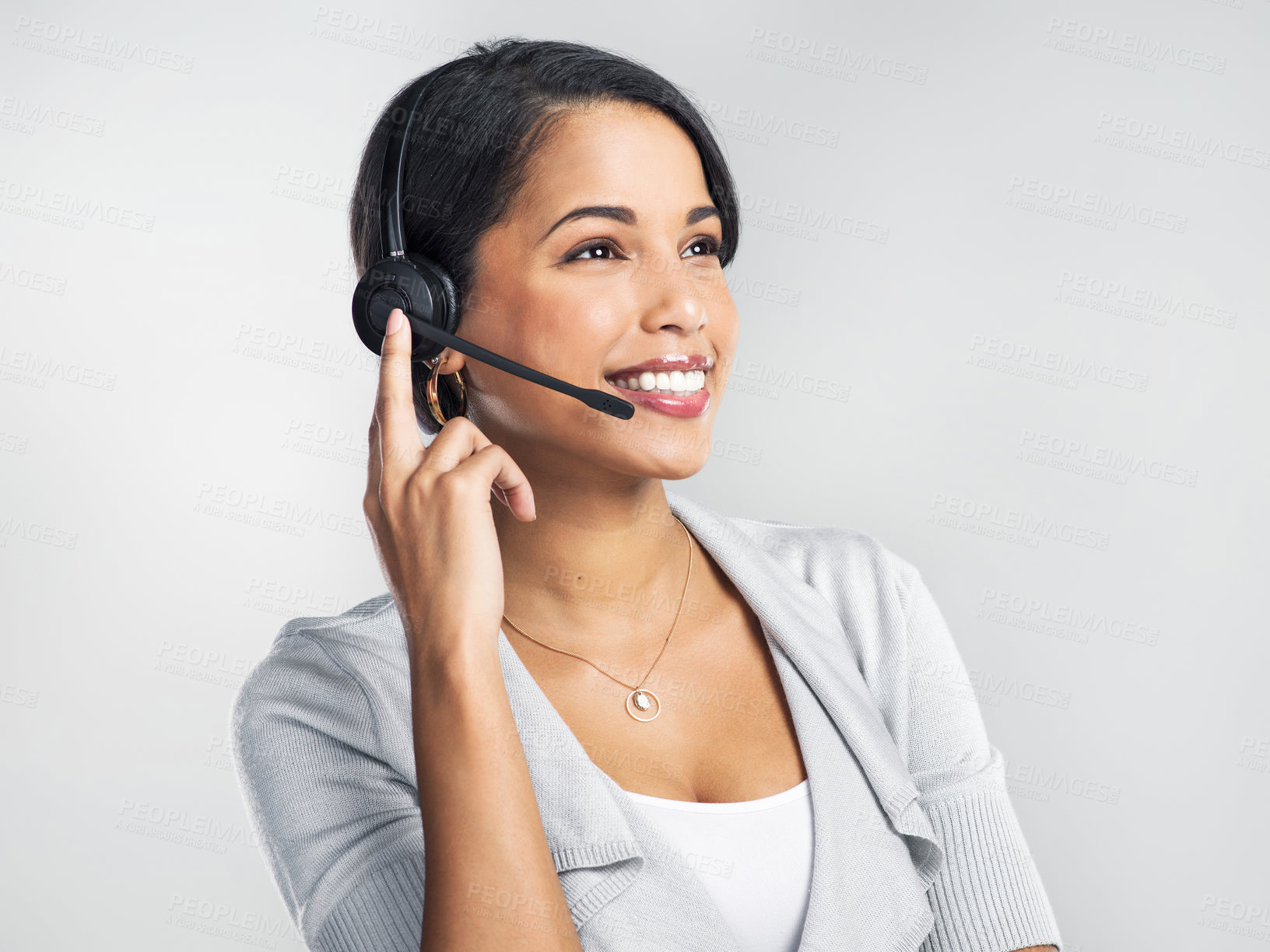Buy stock photo Studio shot of a confident young businesswoman using a headset against a grey background