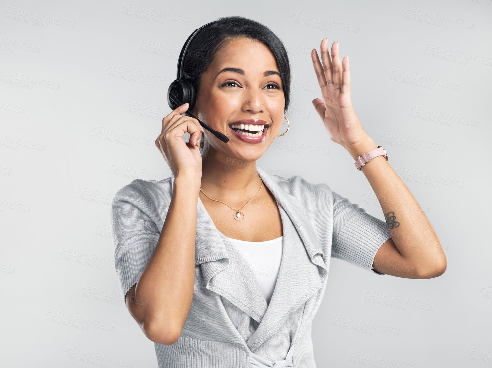 Buy stock photo Studio shot of a confident young businesswoman using a headset against a grey background