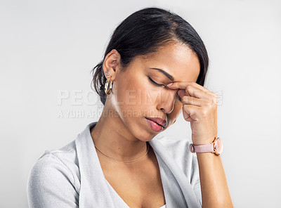 Buy stock photo Studio shot of a young businesswoman looking stressed against a grey background