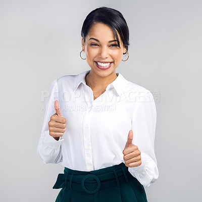 Buy stock photo Studio shot of a confident young businesswoman giving a thumbs up against a grey background
