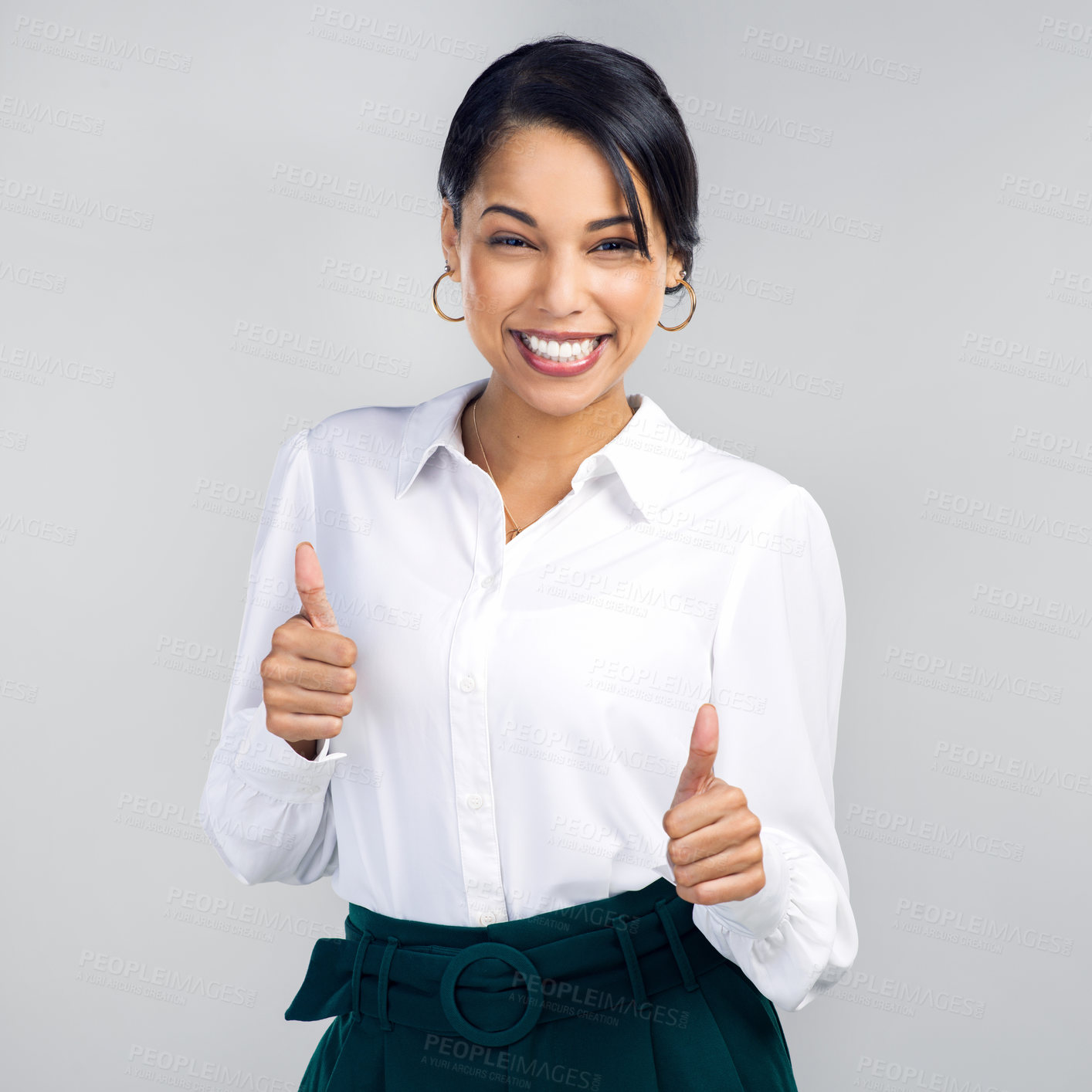 Buy stock photo Studio shot of a confident young businesswoman giving a thumbs up against a grey background