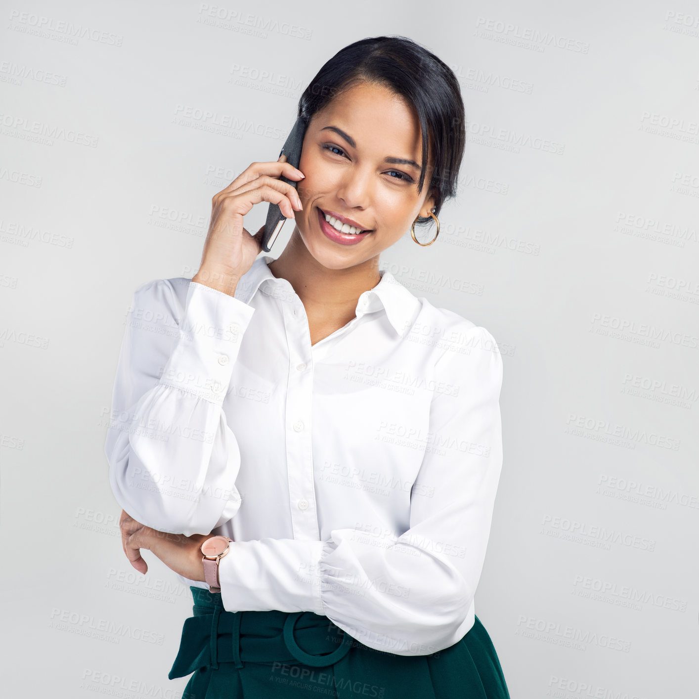 Buy stock photo Studio shot of a confident young businesswoman using a smartphone against a grey background