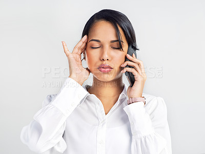 Buy stock photo Studio shot of a young businesswoman using a smartphone and looking stressed against a grey background