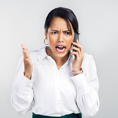 Buy stock photo Studio shot of a young businesswoman using a smartphone and yelling against a grey background