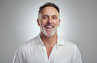 Buy stock photo Studio portrait of a mature man standing against a grey background