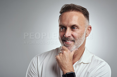 Buy stock photo Studio shot of a mature man looking thoughtful against a grey background