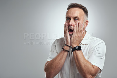 Buy stock photo Studio shot of a mature man looking surprised against a grey background