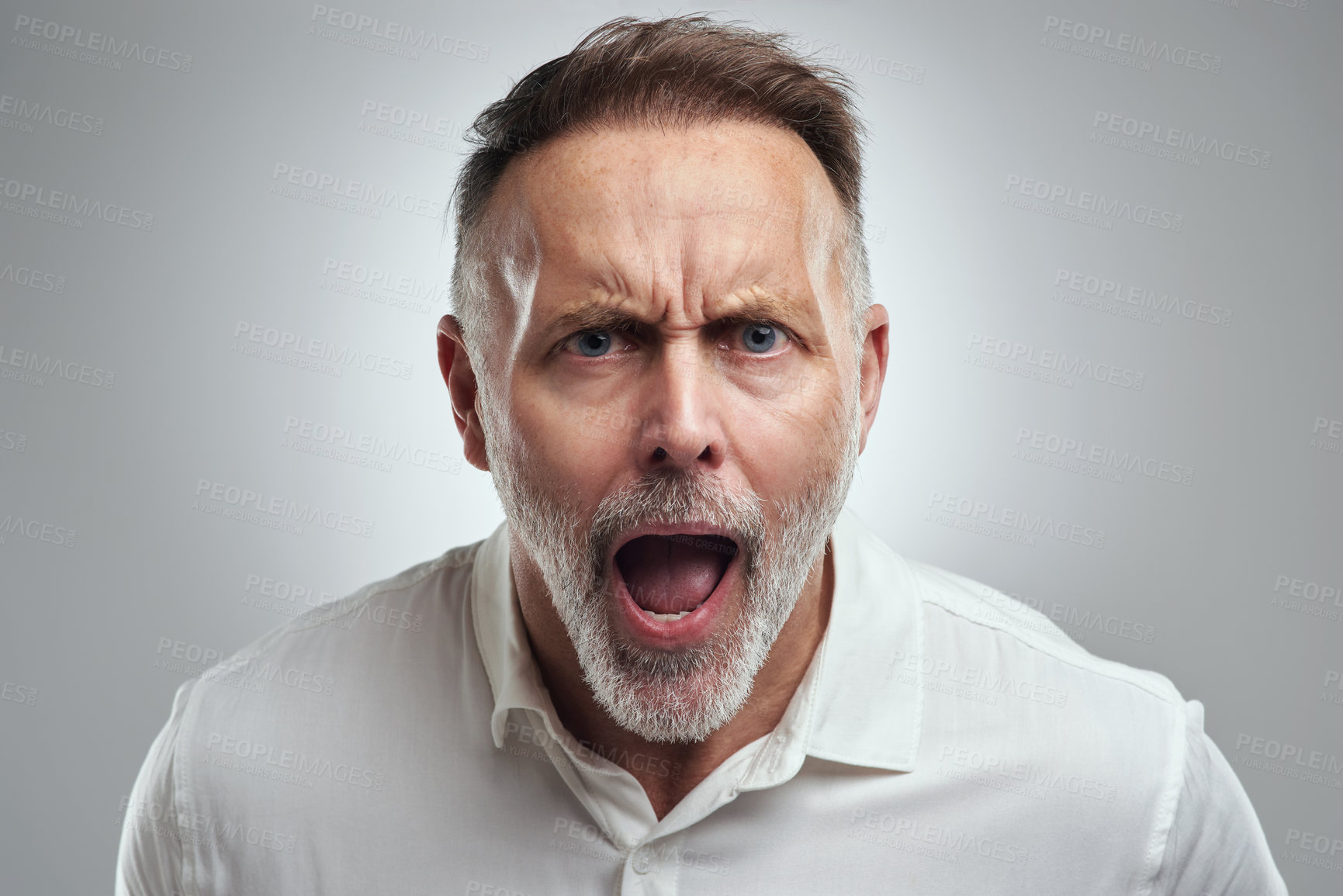 Buy stock photo Studio portrait of a mature man yelling against a grey background