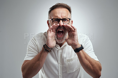 Buy stock photo Studio portrait of a mature man yelling against a grey background
