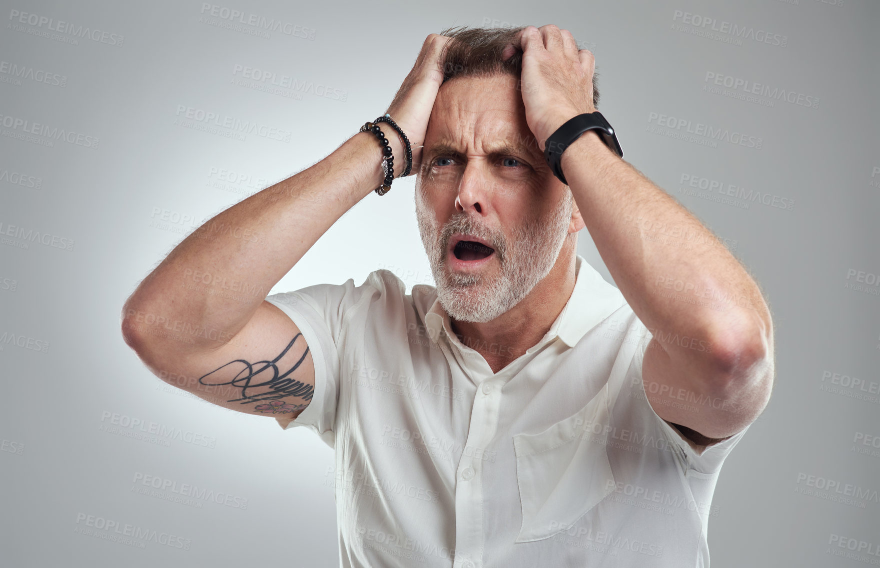 Buy stock photo Studio shot of a mature man looking disappointed against a grey background
