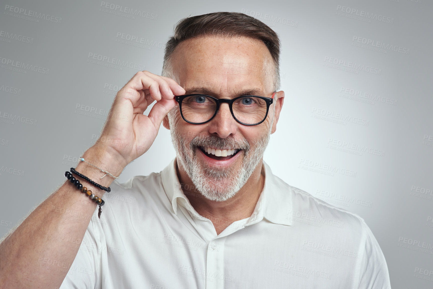 Buy stock photo Studio portrait of a mature man wearing spectacles against a grey background