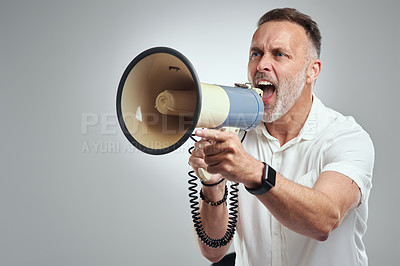 Buy stock photo Studio shot of a mature man using a megaphone against a grey background