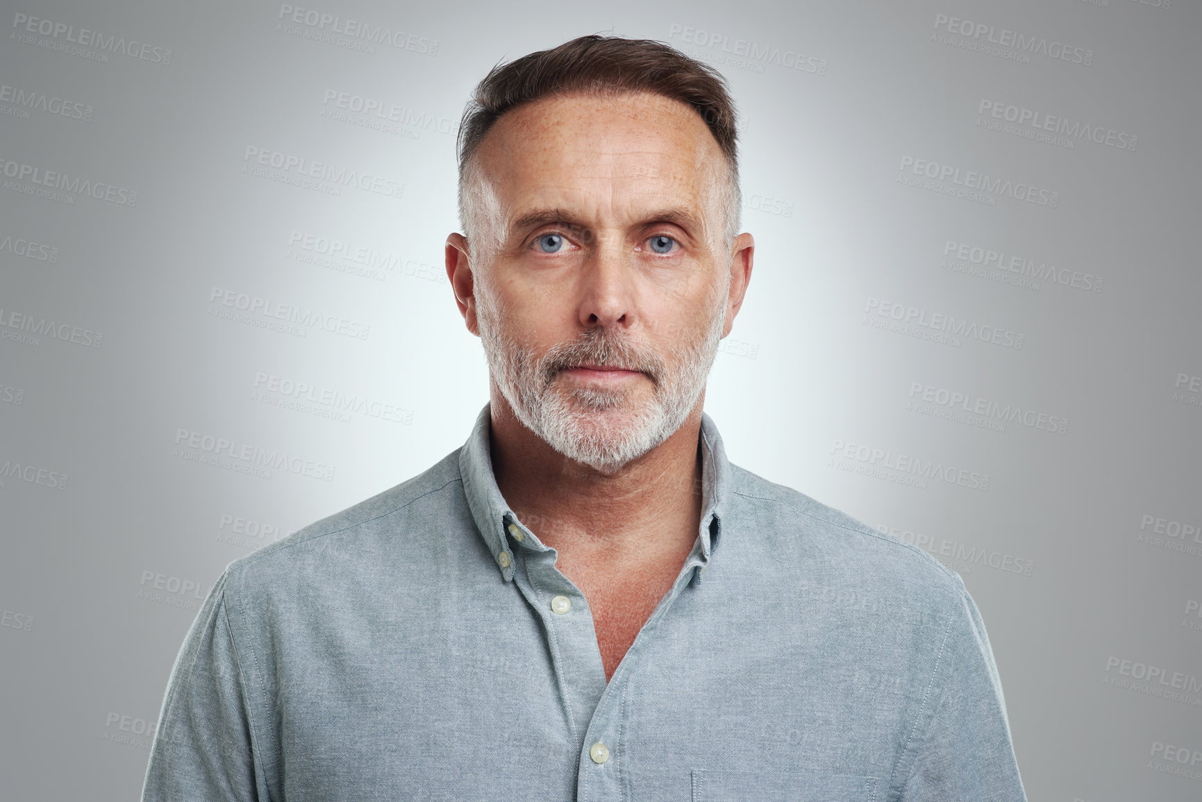 Buy stock photo Studio portrait of a mature man standing against a grey background