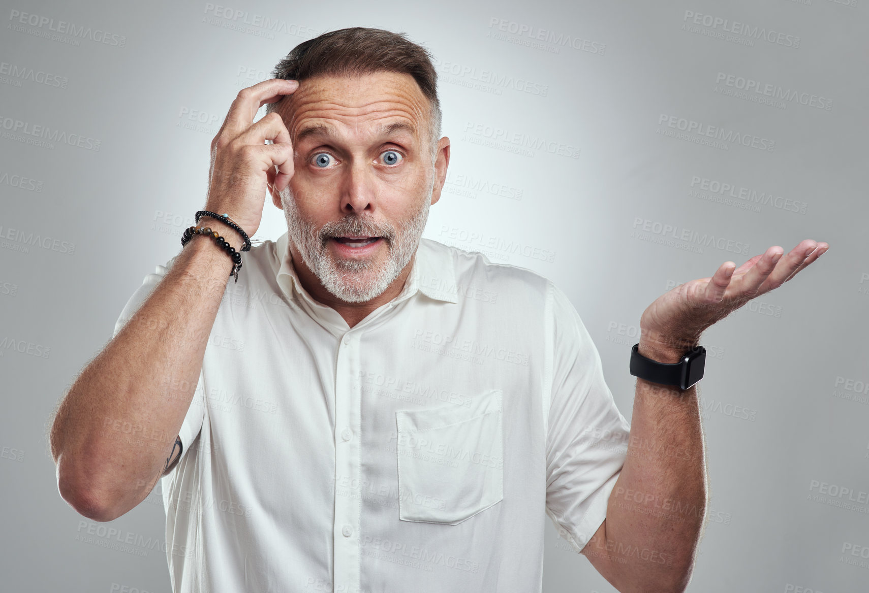 Buy stock photo Studio portrait of a mature man looking confused against a grey background