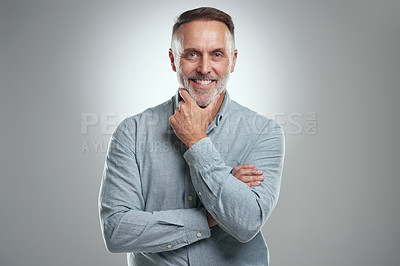 Buy stock photo Studio portrait of a mature man looking thoughtful against a grey background