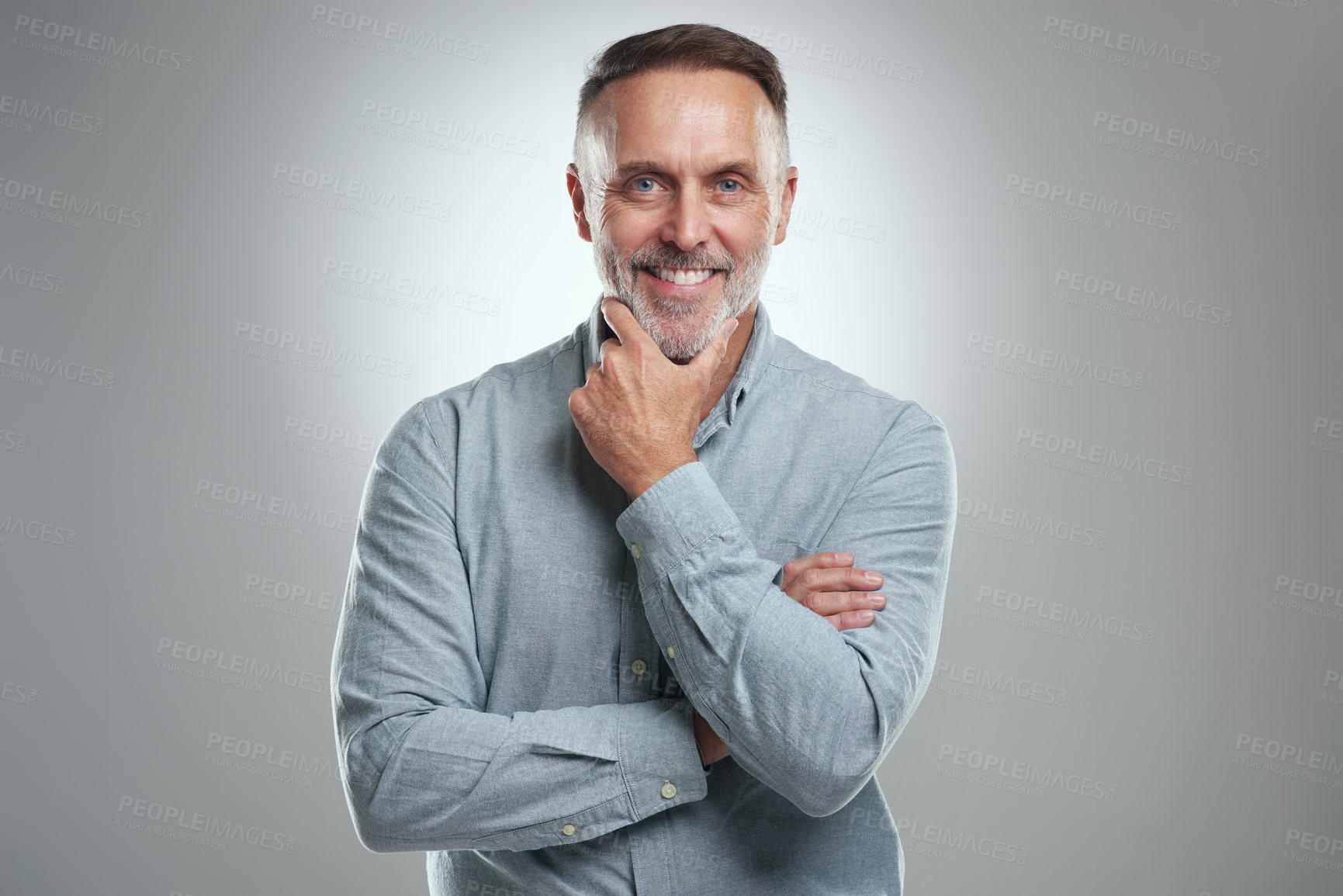 Buy stock photo Studio portrait of a mature man looking thoughtful against a grey background