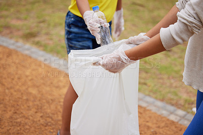 Buy stock photo Charity, earth day and volunteer cleaning trash for climate change outdoors at park to recycle for the environment. Planet, sustainability and community activists to pickup pollution, trash or litter