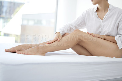 Buy stock photo Bedroom, health and body care legs of girl with epilation beauty treatment for smooth feel. Skincare, hair removal and clean texture of woman touching beautiful and perfect skin in home.

