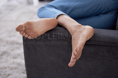 Buy stock photo Cropped shot of a woman's feet while lying on a couch