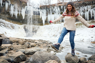 Buy stock photo Full length shot of an attractive young woman spending the day outside during winter