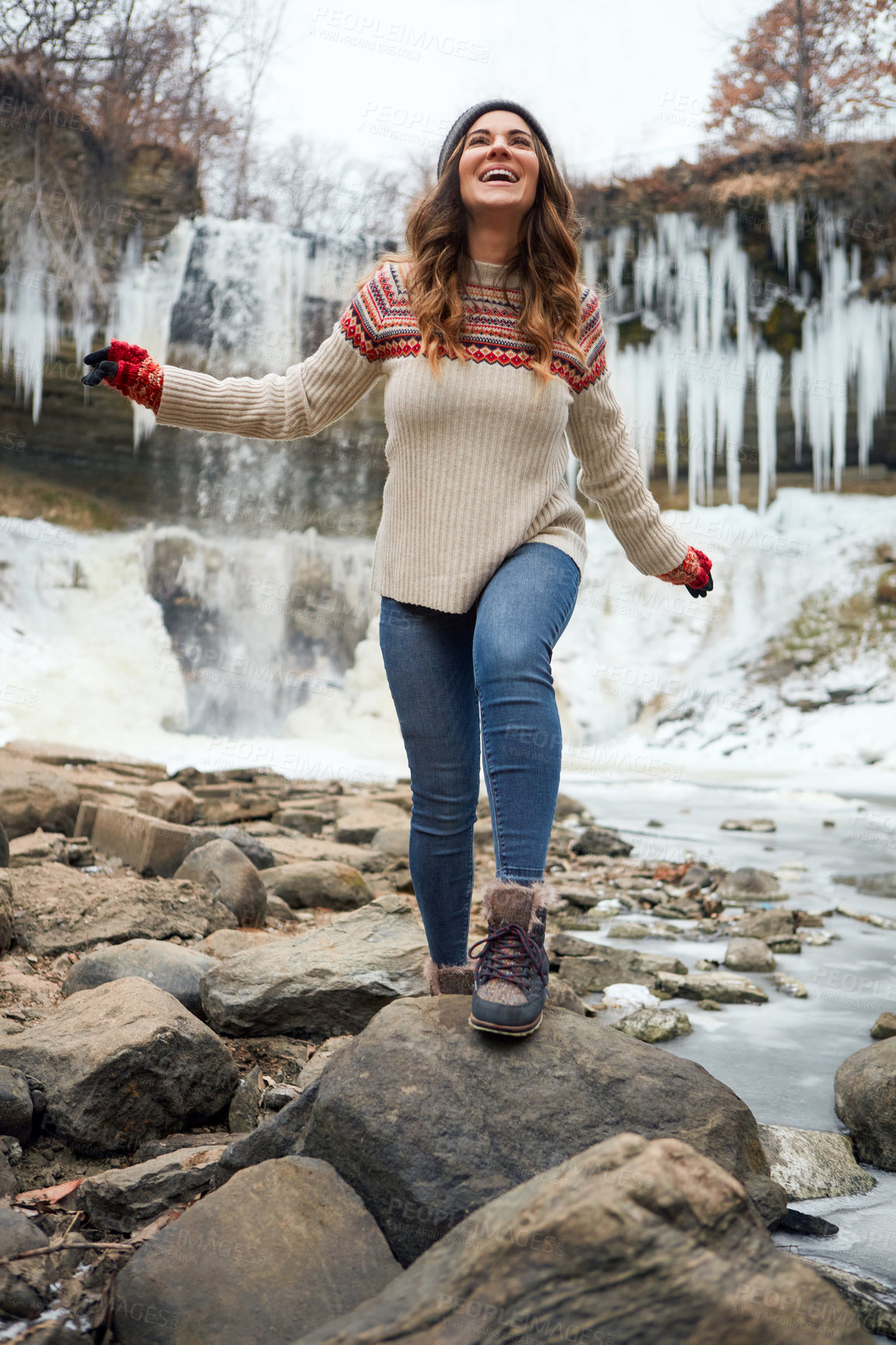 Buy stock photo Full length shot of an attractive young woman spending the day outside during winter