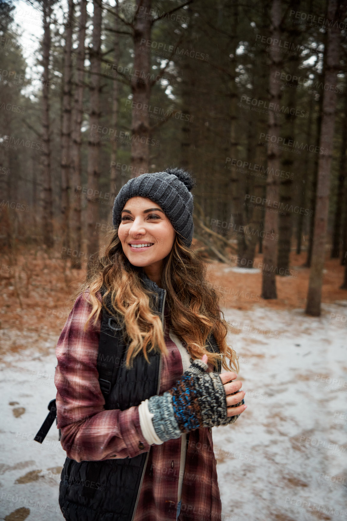 Buy stock photo Shot of a young woman hiking in the wilderness during winter