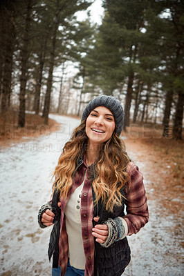 Buy stock photo Portrait of a young woman hiking in the wilderness during winter