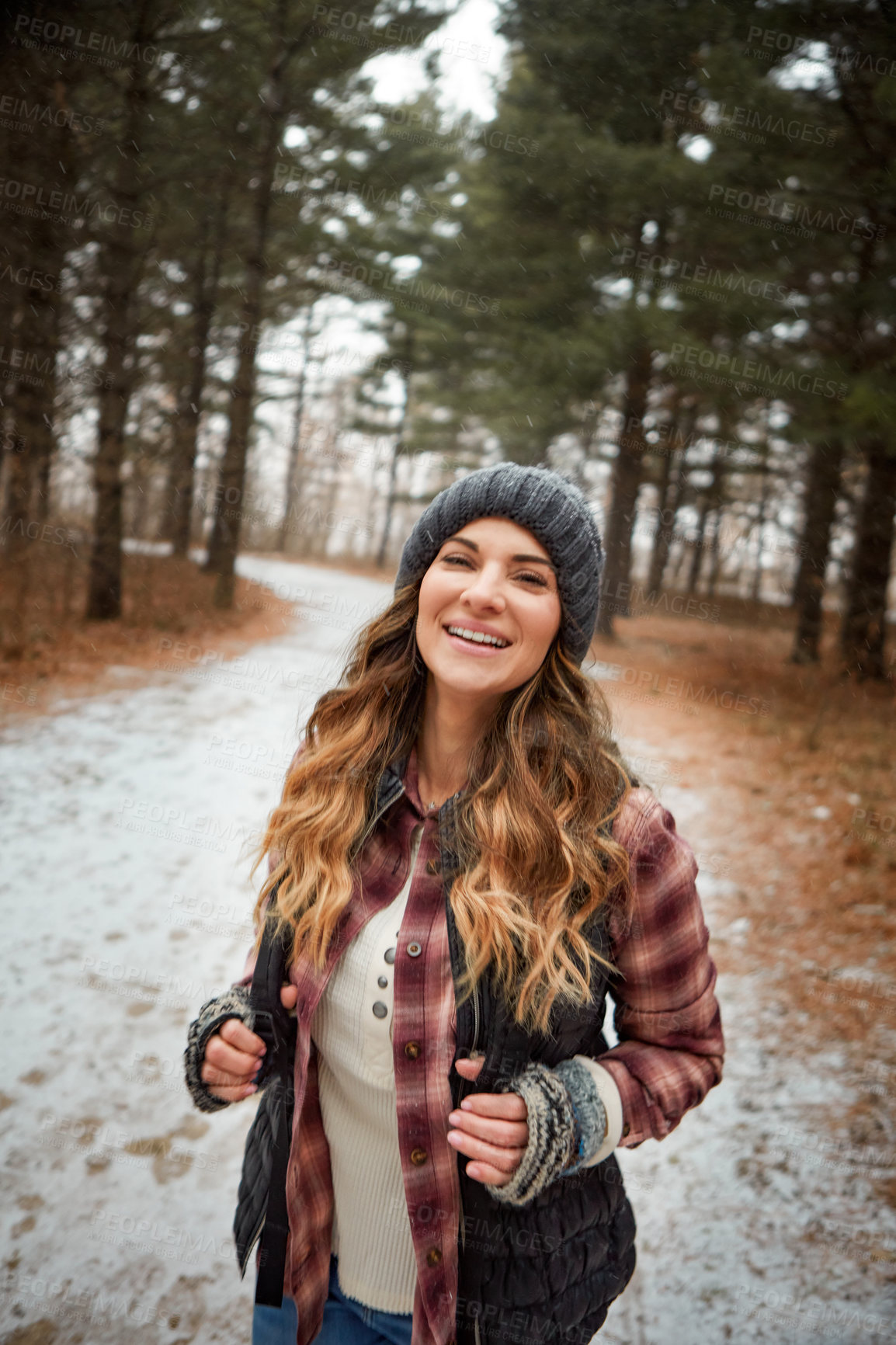 Buy stock photo Portrait of a young woman hiking in the wilderness during winter