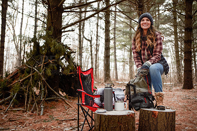 Buy stock photo Shot of a young woman camping in the wilderness during winter