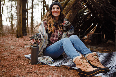 Buy stock photo Shot of a young woman camping in the wilderness during winter