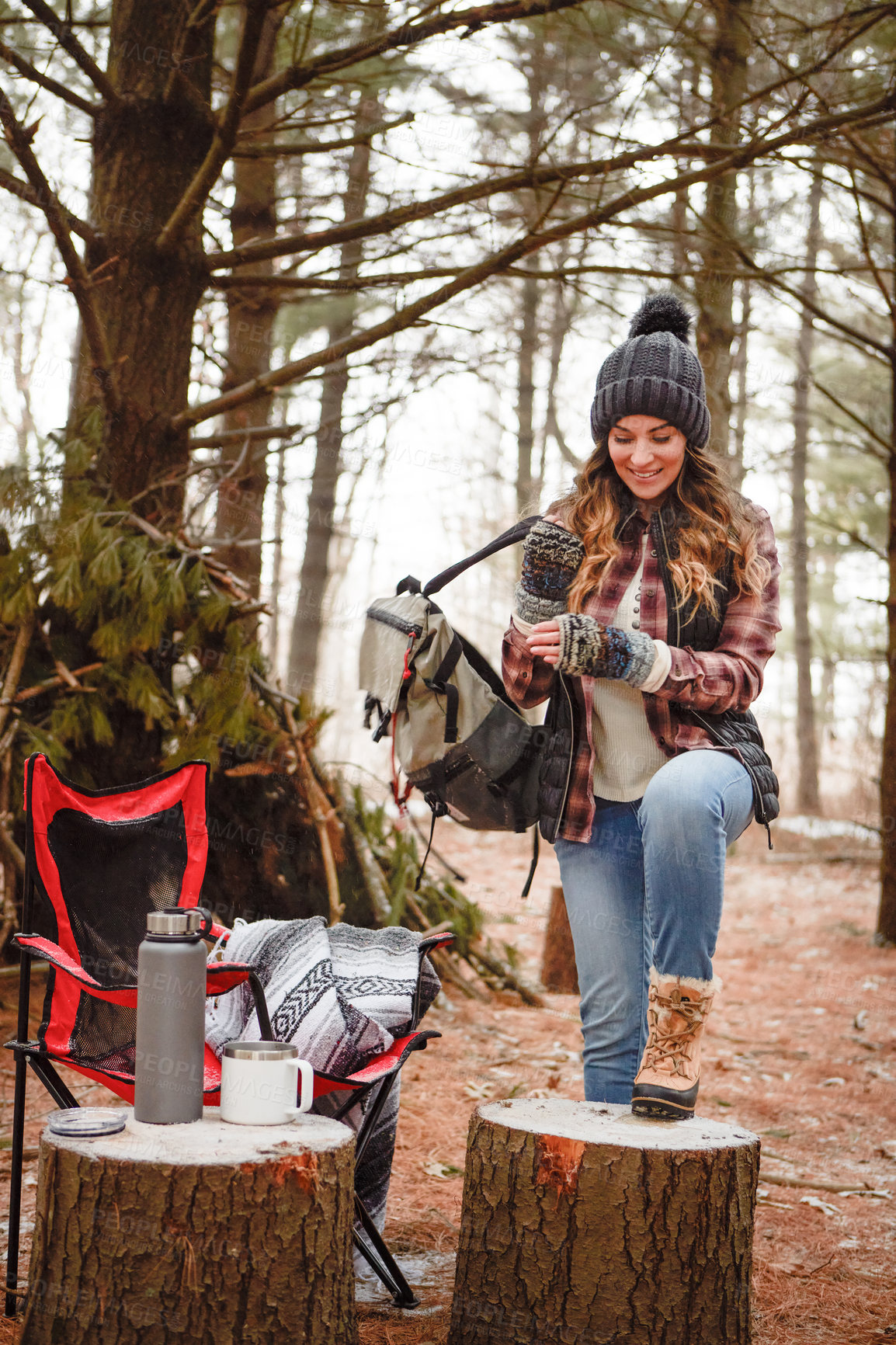 Buy stock photo Shot of a young woman camping in the wilderness during winter