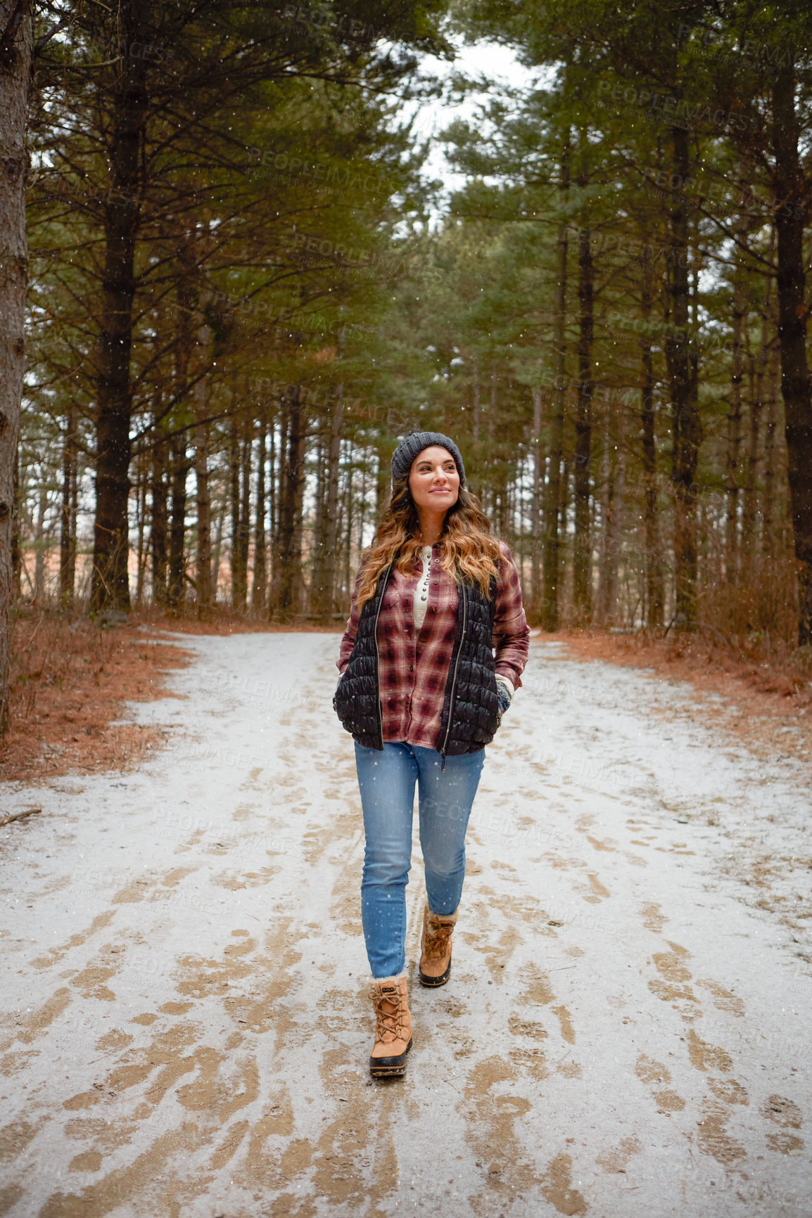 Buy stock photo Shot of a young woman hiking in the wilderness during winter