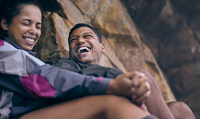 Buy stock photo Cropped shot of an affectionate young couple laughing while taking a break during their early morning hike
