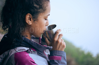 Buy stock photo Cropped shot of an attractive young woman drinking coffee while taking a break during her early morning hike